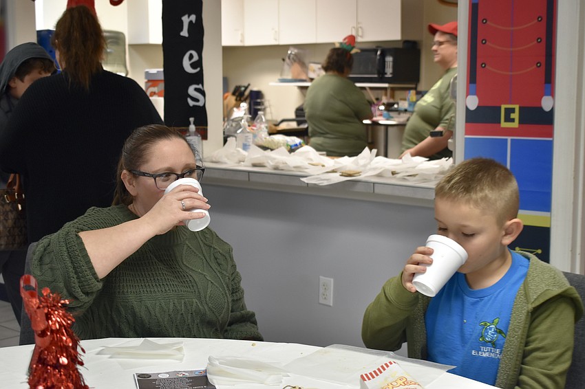 Charity Driggers and Logan Driggers, 7, down their hot chocolate.