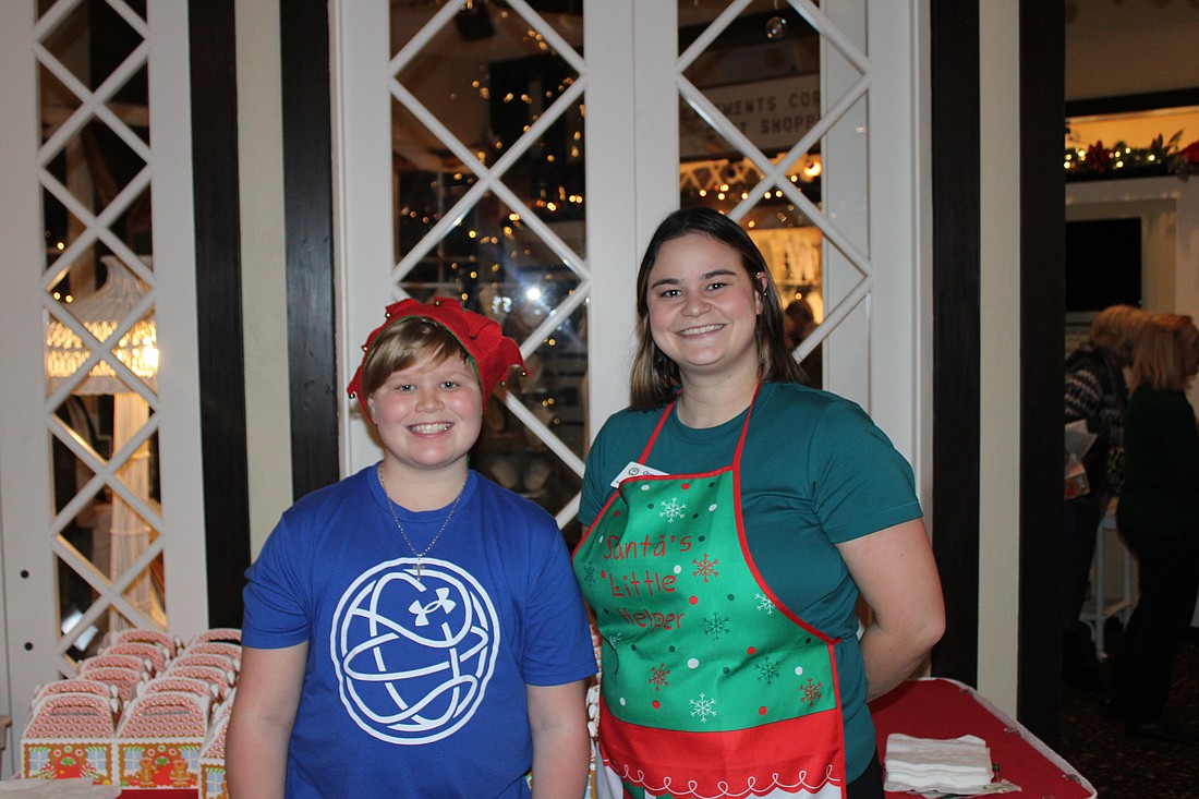 Aiden Carolin and Sara Dionne greet guests with treat boxes. Photo by Alexis Miller