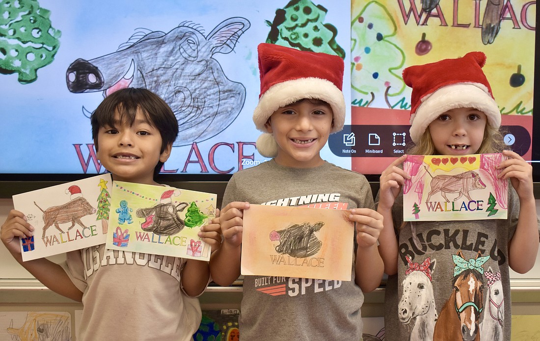Lian Guerra Lopez, Luis Posso and Ember Aberegg are first graders at Myakka City Elementary School. The Myakka Co-op partnered with the school on a Christmas card fundraiser.