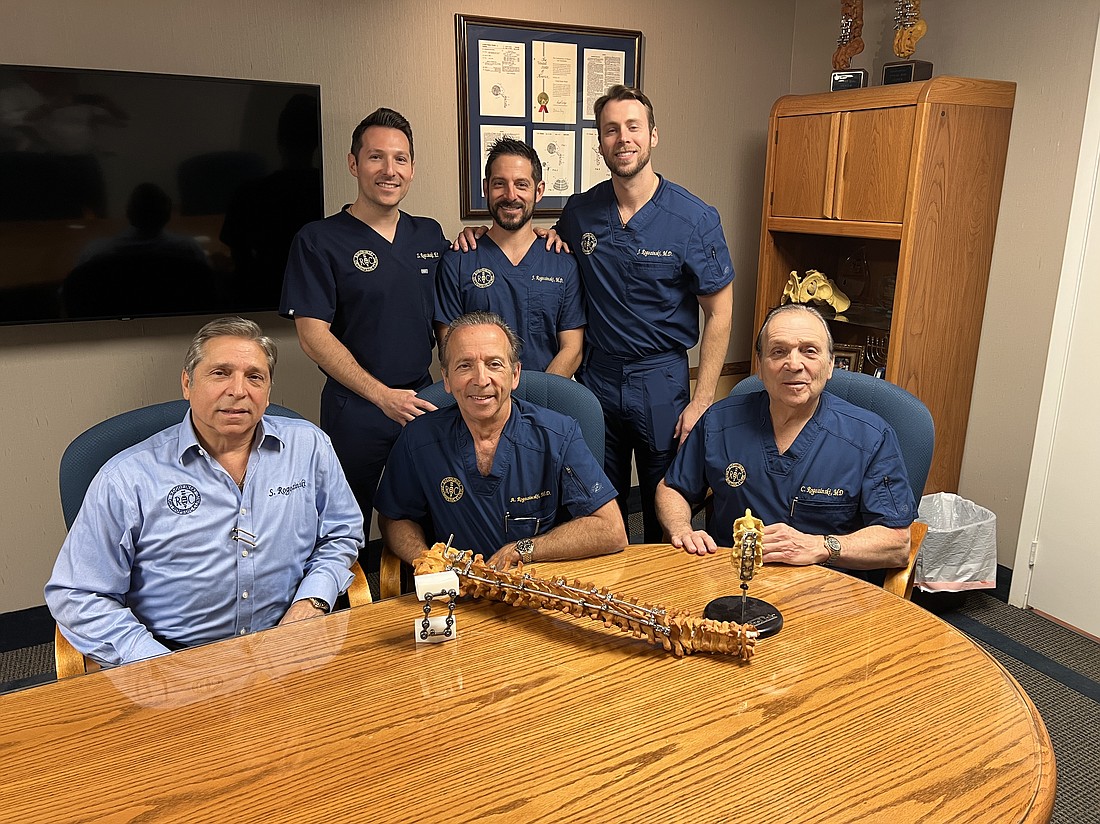 The Rogozinskis: Seated from left, Sam, Abe and Chaim. Standing from left, Zachary, Josh and Jonathan. They work together at Rogozinski Orthopedic Clinic at 3716 University Blvd. S., Suite 3, in Jacksonville. On the table are implantable medical braces Chaim and Abe Rogozinski invented.