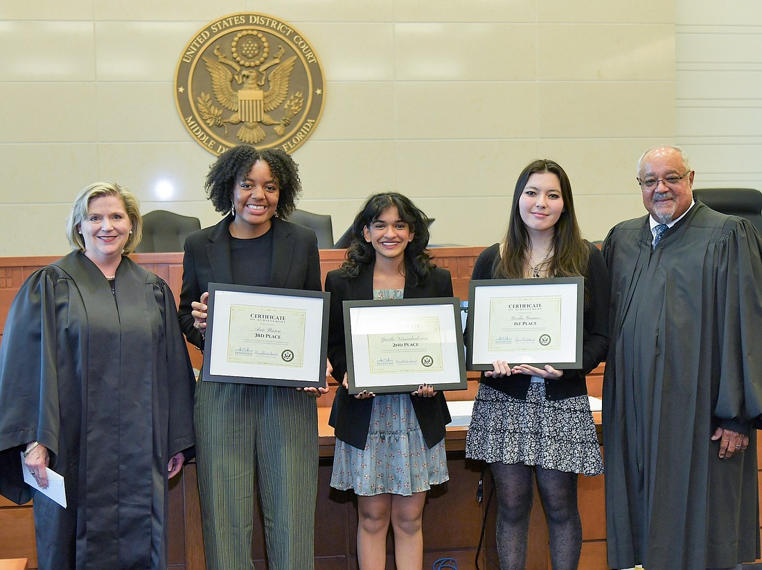 U.S. District Judge Marcia Morales Howard with the winners of the 2023 High School Essay Contest, from left, third-place winner Aria Brown; second-place winner Spurthi Nrusimhadevara; first-place winner Cecilia Connor; and U.S. District Judge Brian Davis.
