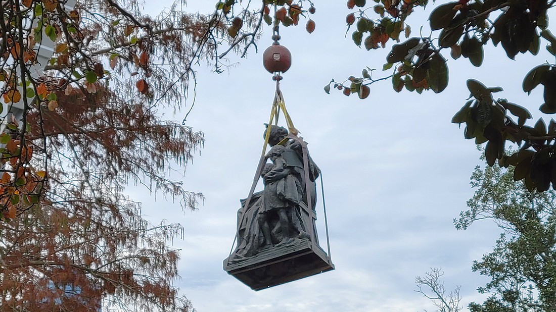 The Tribute to the Women of the Southern Confederacy monument is lifted from Springfield Park on Dec. 27.