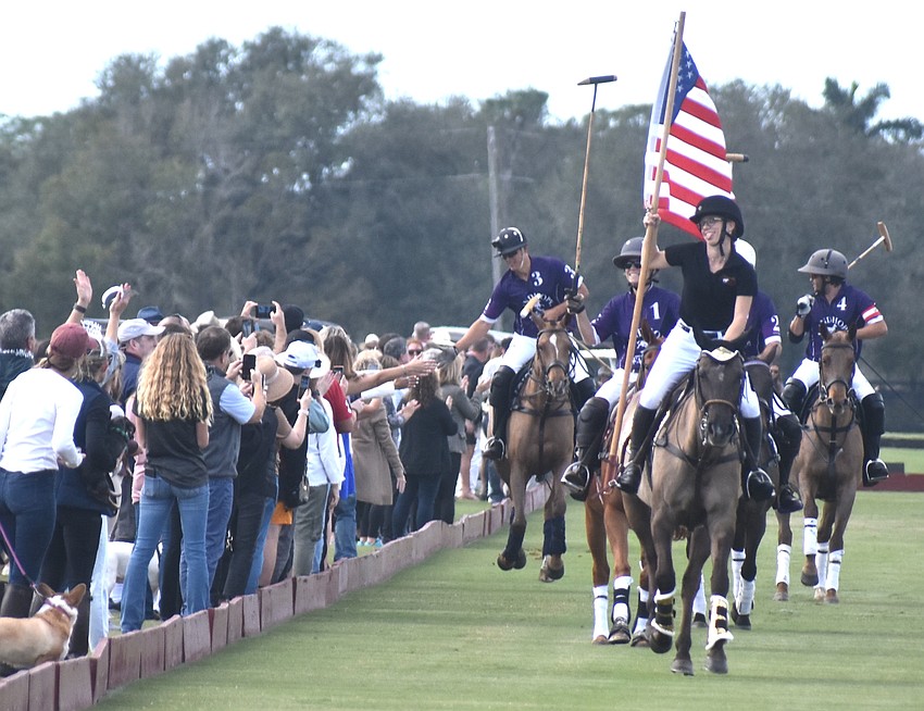 Paige Lautzenheiser presents the colors during the opening parade at the Sarasota Polo Club Dec. 31.