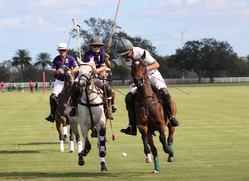 Michael Bucklin and Camille Ricaud of the Landhope team can't catch Barefield/Rawhide Creek's Mark Mulligan, who scores on his shot. Landhope had the last laugh, winning 8-5.