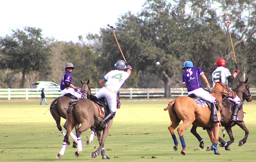 Barefield/Rawhide Creek's Vasco Iriarte comes out of the saddle to drive the ball down the field against Landhope in the season opener at the Sarasota Polo Club.