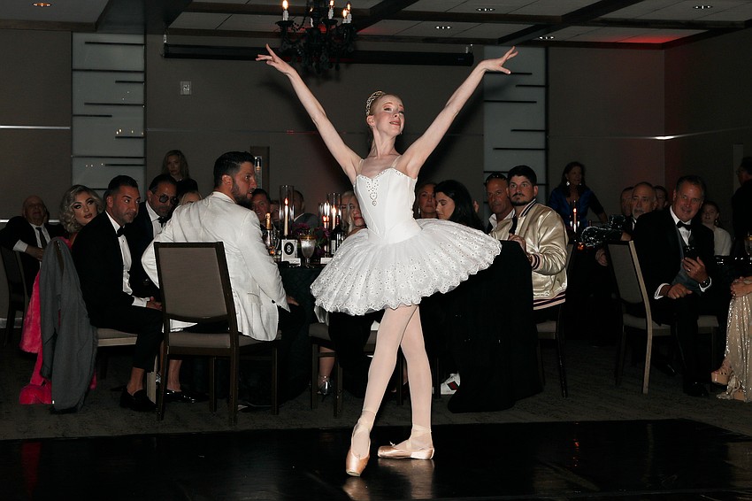 From the Sarasota Ballet's Margaret Barbieri Conservatory is Macie Miersch, 14, who performs a classical ballet dance between dinner courses.