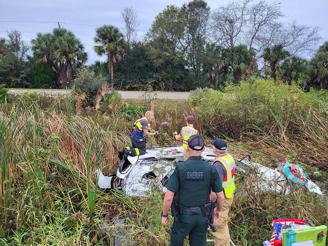 Ormond firefighters rescue presents from a submerged vehicle on Dec. 25. Photo courtesy of VSO's Facebook page