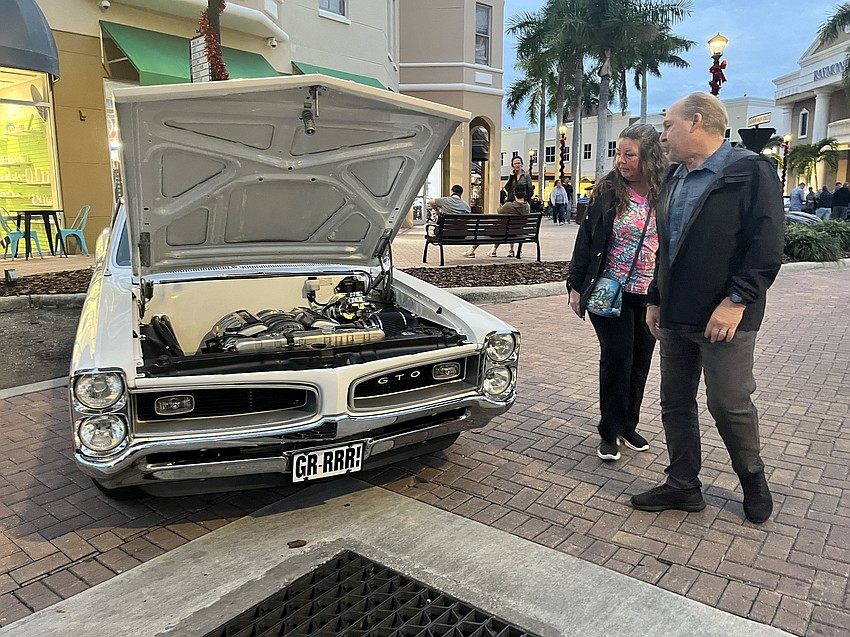 Ellenton's Kelly and John Higgins enjoy the car show on Main Street at Lakewood Ranch for the first time. Kelly Higgins says the car show is a part of a Christmas gift in which they gave each other experiences rather than material objects.