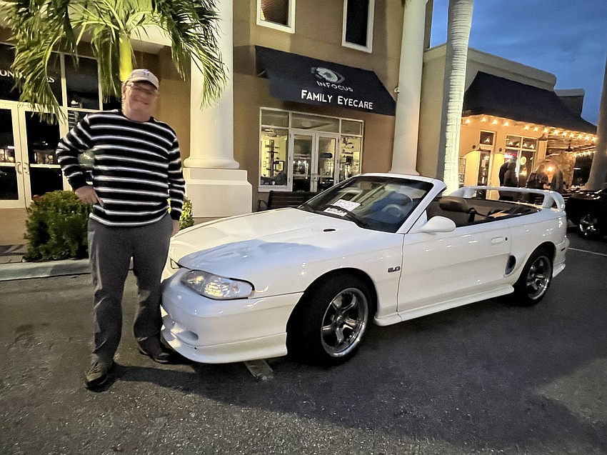 Sarasota's Mike Mahoney showcases his 1995 Mustang GT convertible with its off-center stripe and spoiler. 