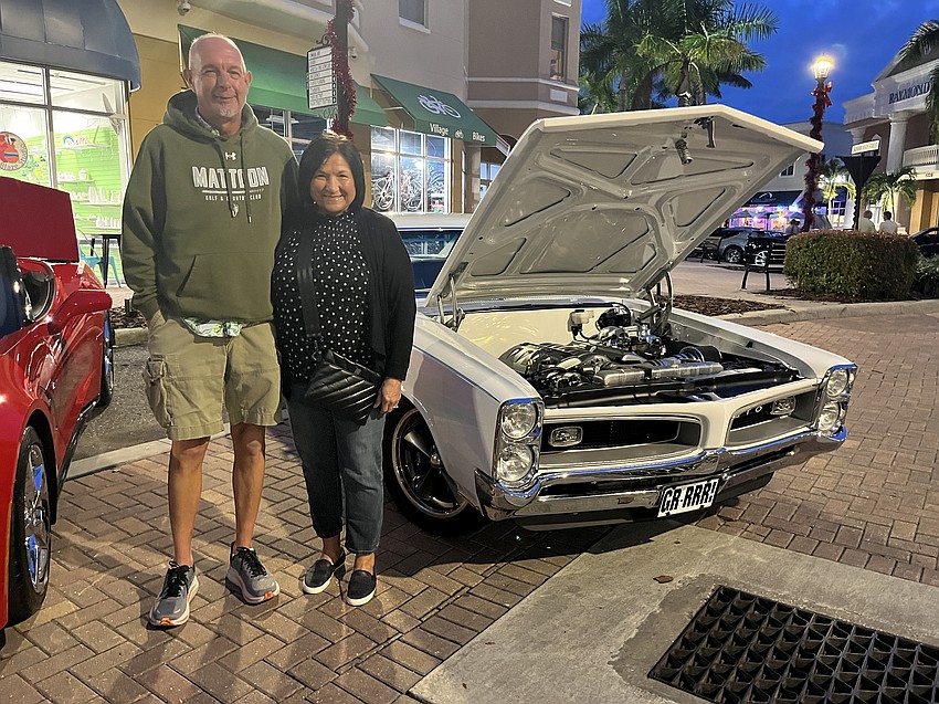 Rick Haskett and Ellie Haskett peruse cars during a visit from Mattoon, Illinois. 