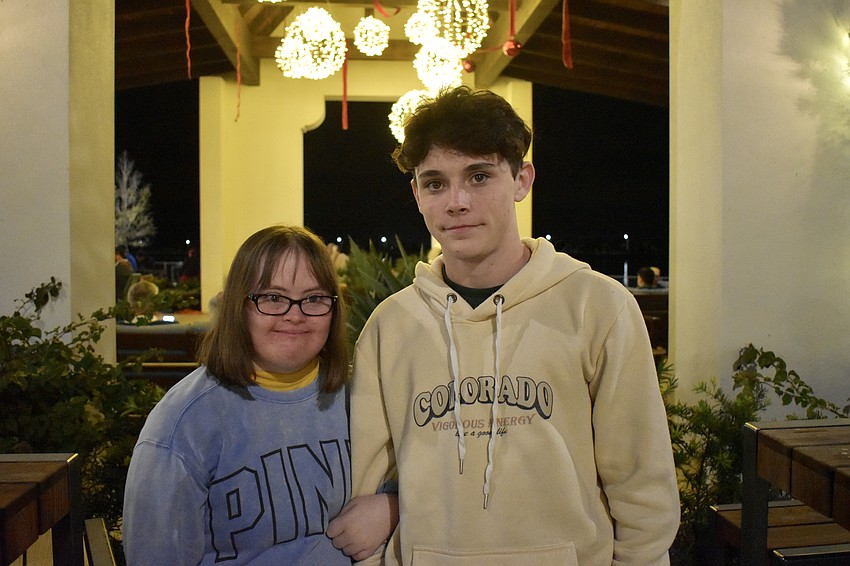 Siblings Ella and Dylan Quaid enjoy the music after eating a burger and a lobster roll from the food trucks.