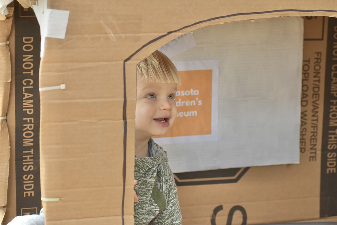Harry Strunk, 2, explores inside a cardboard tunnel.