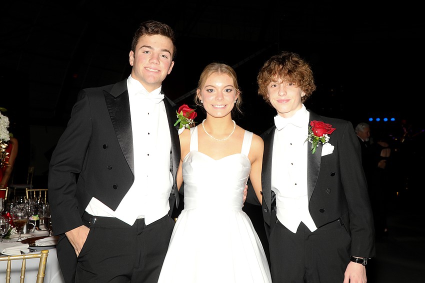 Debutante Emma Harrigan and her escorts, Will MacKinnon and Noah Rosser.