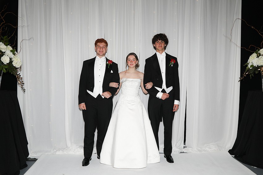 Debutante Andrea Pellizzari and her escorts, Alexander Tewfik and Nicholas Cutler.