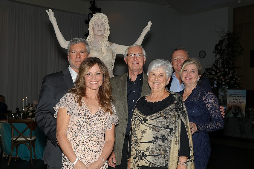 Christine and Chad Kasten, Sarah and Curt Kasten, and Heather and Clint Kasten admire living statue artist Timmia Cirque Vertigo.