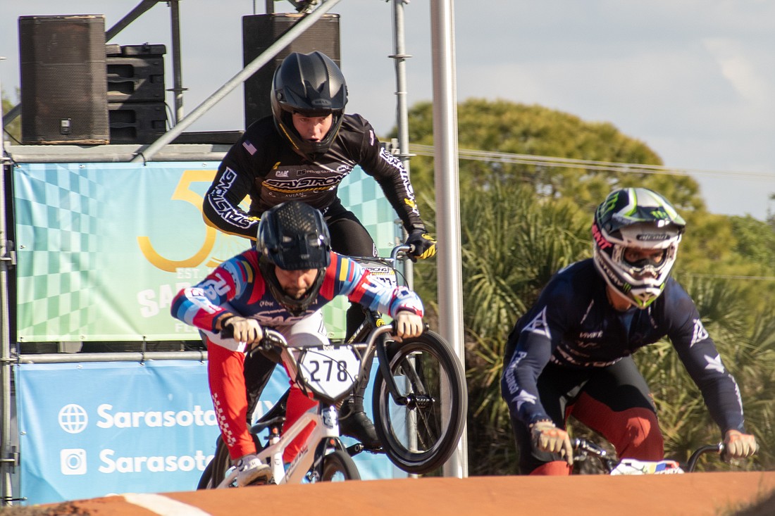 Joey Leto (black jersey) gets air while racing on day one of the 2024 USA BMX Sunshine State Nationals at Sarasota BMX.