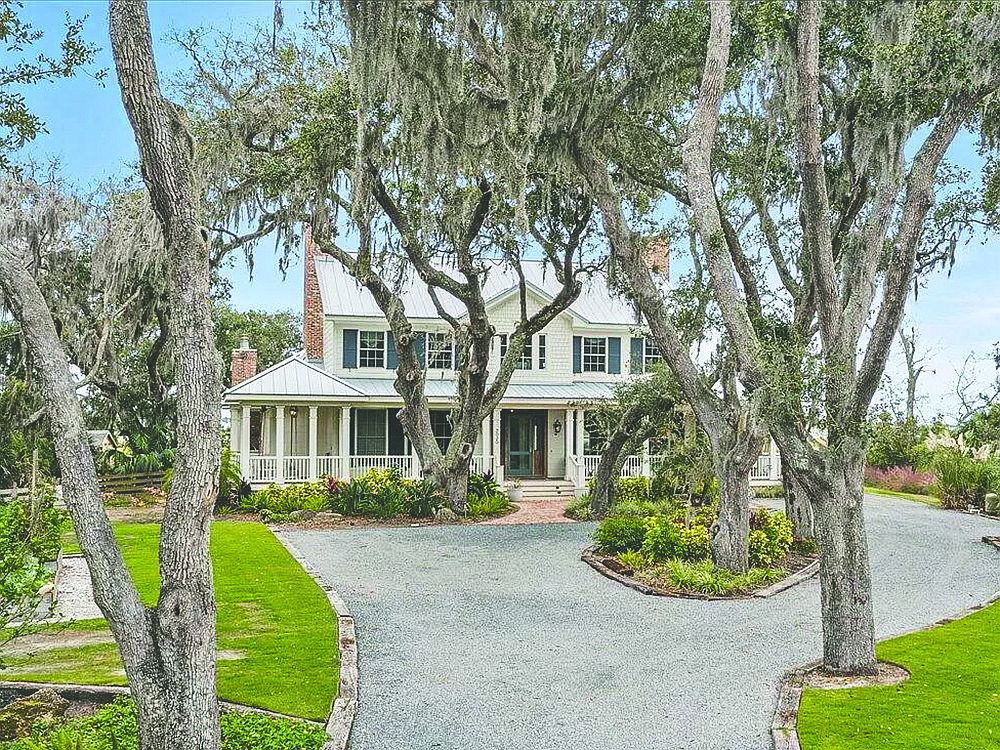 Lowcountry-style two-story home on the Intracoastal Waterway features five bedrooms, four bathrooms, wraparound porch, patio, carport and dock.