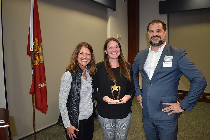 Nicole Ryskamp, left, and Keith Pandeloglou, right, present SMR's Sandy Shahinian with the Collaborator of the Year Award.