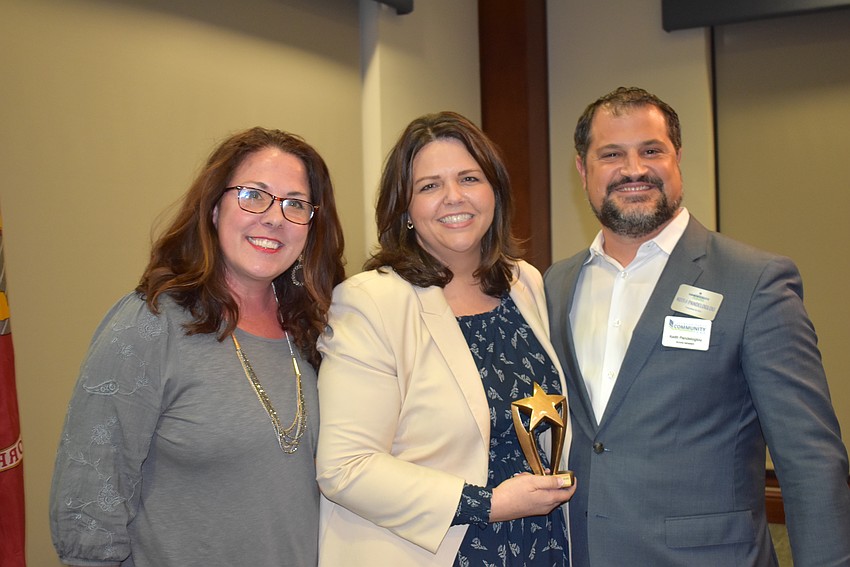 Jennifer Kovatch (left) and Keith Pandeloglou (right) of Lakewood Ranch Community Activities present the Volunteer of the Year Award to Lakewood Ranch's Monaca Onstad.