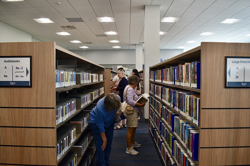 Patrons browse the collection of 45,000 books, audiobooks and DVDs.