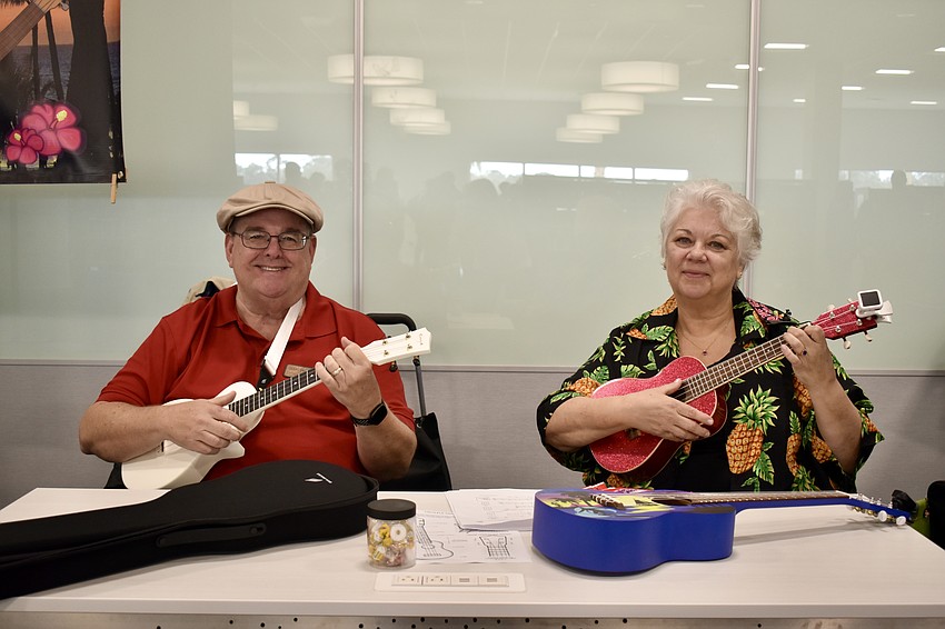 Carl Buckman and Alice Baumann from Aloha Ukulele of Lakewood Ranch offer songs and lessons at the grand opening.