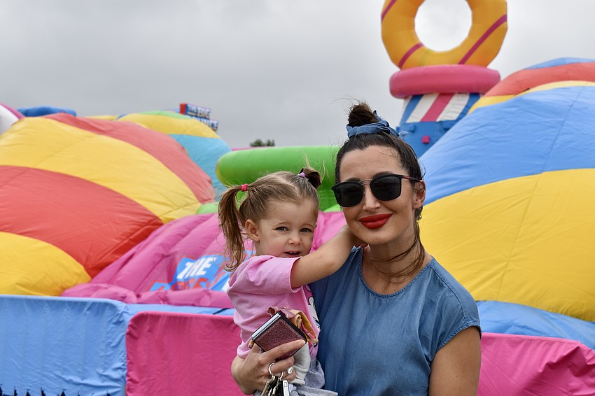 Friday is the only day toddlers can bounce, so 2-year-old Nela Gvozdenovic and her mom Nicole are waiting out the wind.