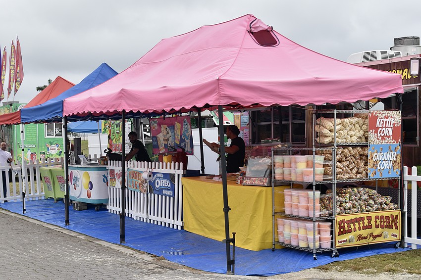 A row of tents offers every kind of circus or carnival treat guests could want.