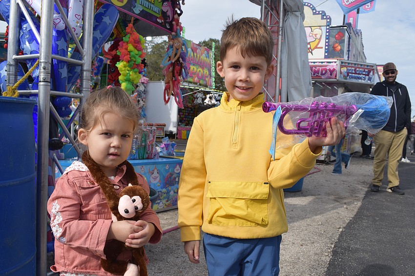 Myakka City 2-year-old Emilia Arbelaez and 4-year-old Ian Arbelaez show off the prizes they won.