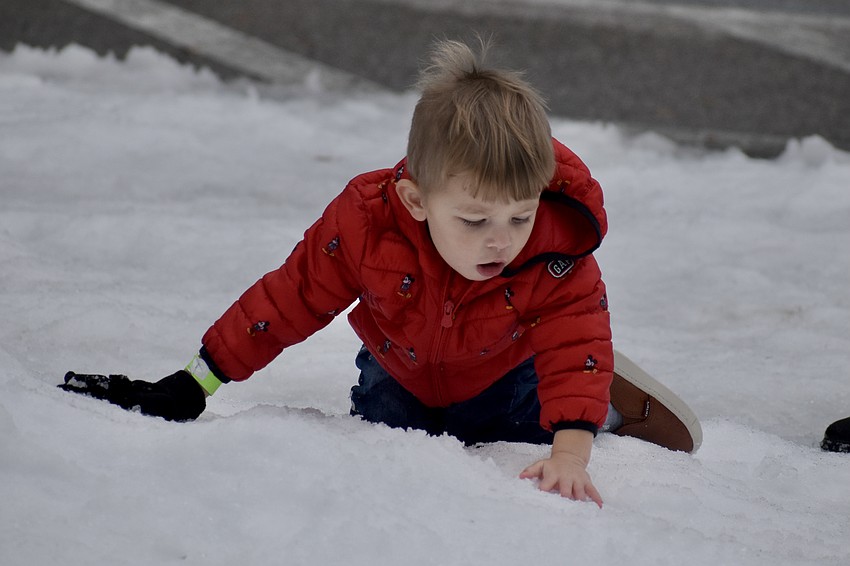 Ozzy Pirner, 2, discovers the wonders of snow in Florida.