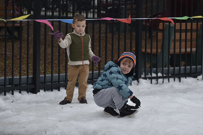 Leo Biter, 3, tosses a snowball at Luke Bresler, 4.