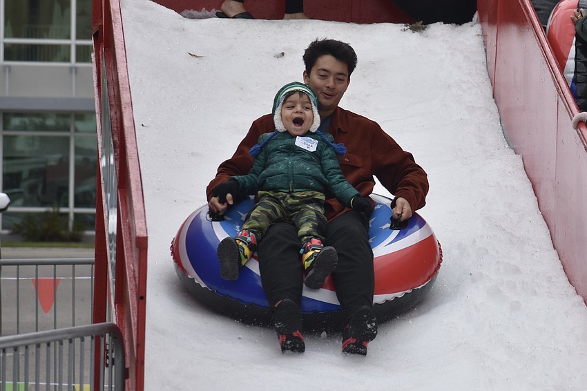 Noah DaSilva, 4, and Brayan DaSilva slide down the slope together.