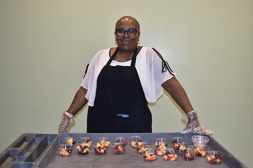 Eva Williams-White staffed a fruit stand outside the auditorium of the awards ceremony, part of the breakfast offerings that were available.