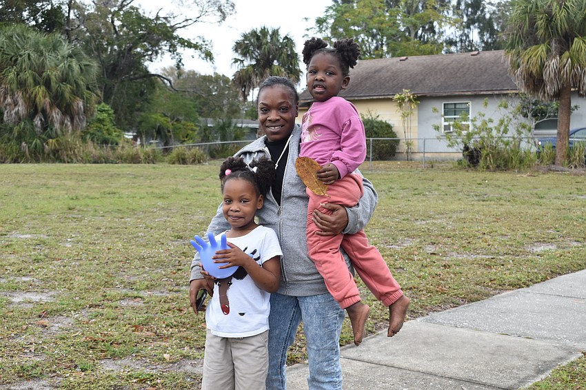 Madysyn Sorey, 6, Latisha Sorey and Jermonie Steen, 3, were among those who headed outside to watch the walk.