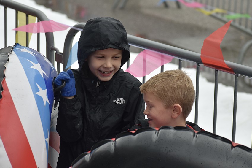 Cason West, 6, and Roman Sites, 6, wait in line for the slide.