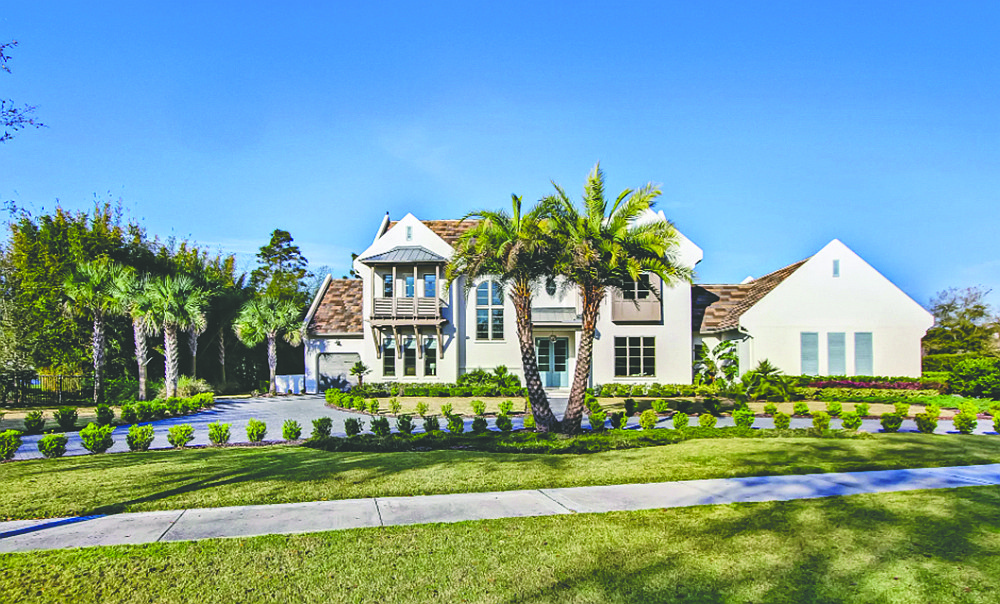 Lakefront two-story home in Pablo Creek Reserve features five bedrooms, six full and one half-bathrooms, guest suite, office, gym, porches, outdoor kitchen and infinity pool.