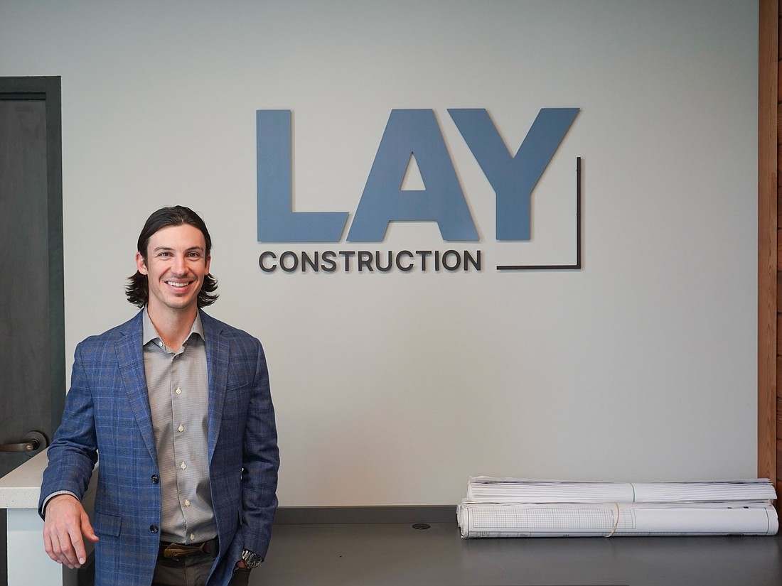 Coleman Lay, the owner of LAY Construction, with the new logo for his company.