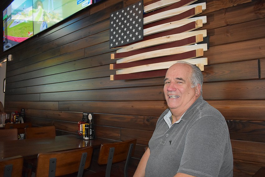 One of co-owner Bob Bender's favorite spots in the restaurant is under the wooden flag in the new Ed's Tavern.