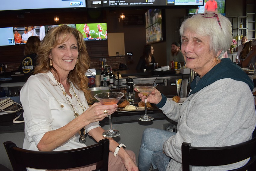 Parrish's Kristen Whidden and Braden Oaks Joyce Rhodes enjoy a cocktail during the soft opening on Friday of the new Ed's Tavern.