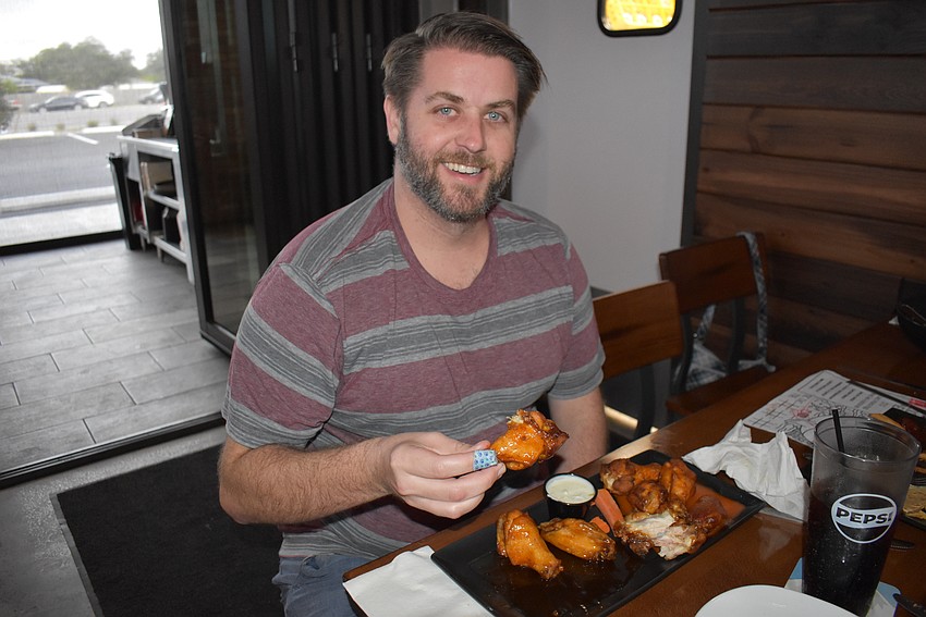 Parrish's Sean Driscoll checks out the wings at the new Ed's Tavern.