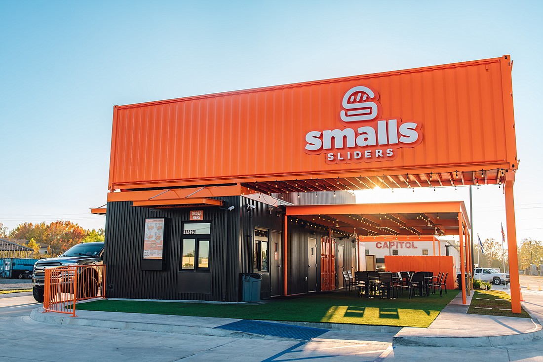 The Smalls Sliders restaurants, which the company calls "cans," are bright orange and resemble a long trailer.