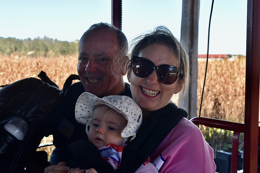 Mark and Lexi Goldman take baby Lexi on a train ride through Hunsader Farms.