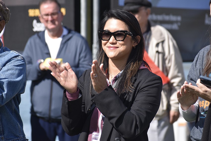 Embracing Our Differences board member Christina M. de Guia applauds a presentation.