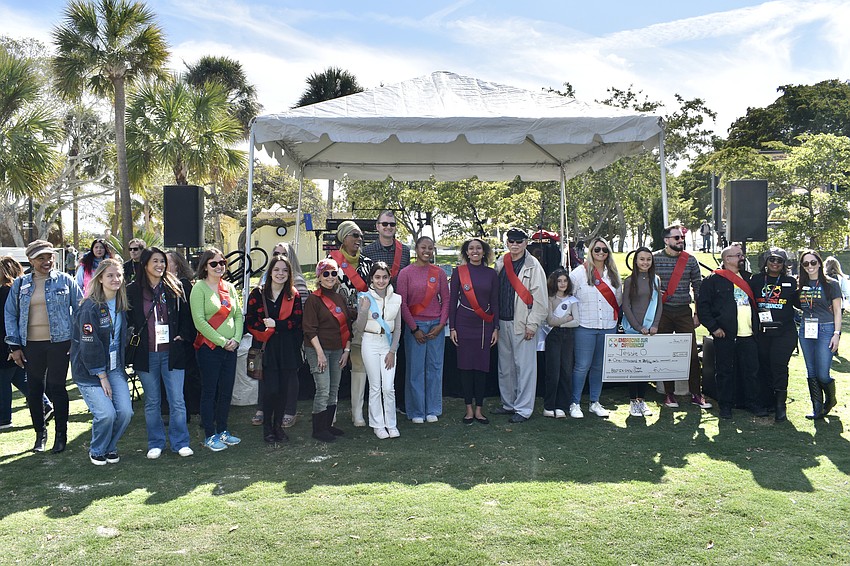 Winning artists and other event participants ather together.