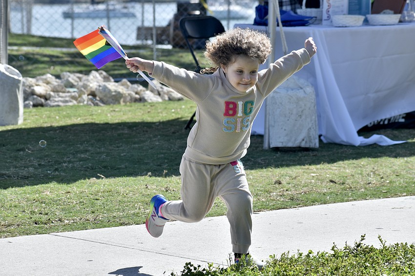 Calla Whelan, 3, leaps into the spirit of the event.
