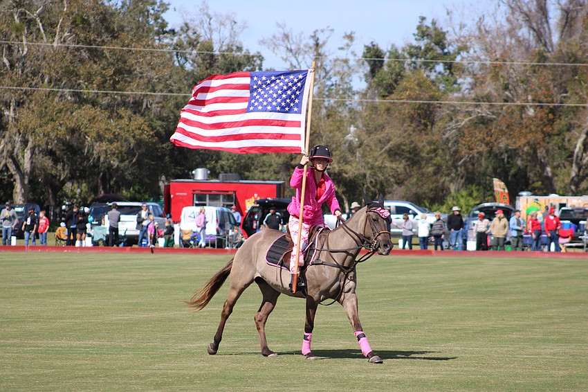 Paige Lautzenheiser, the Sarasota Polo Club's director of operations, presents the colors last season.