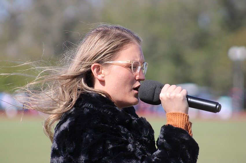 The Music Compound's Amanda Yoder sang the National Anthem.