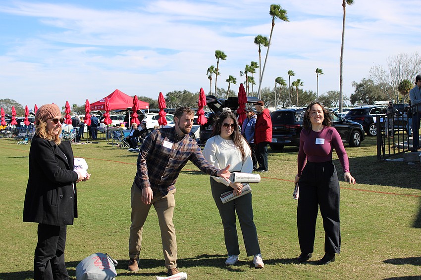 Matthew Buckley tries his hand at landing an East County Observer on a front door mat during halftime at the Sarasota Polo Club on Jan. 21. Those who were successful won an Observer hat.