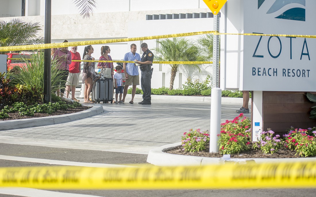 Authorities speak to guests outside the Zota Beach Resort on Aug. 4, 2017, after a double homicide took place at the resort.