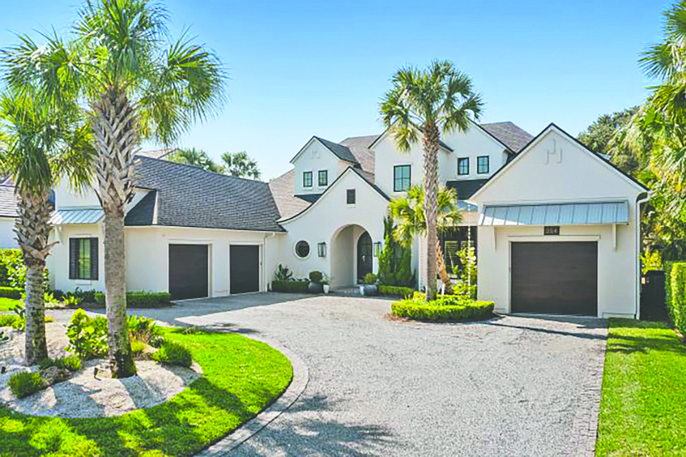 Old Ponte Vedra Beach two-story home with golf course views features four bedrooms, five full and one half-bathrooms, office, guest suite, wine room, porches, patio and pool.