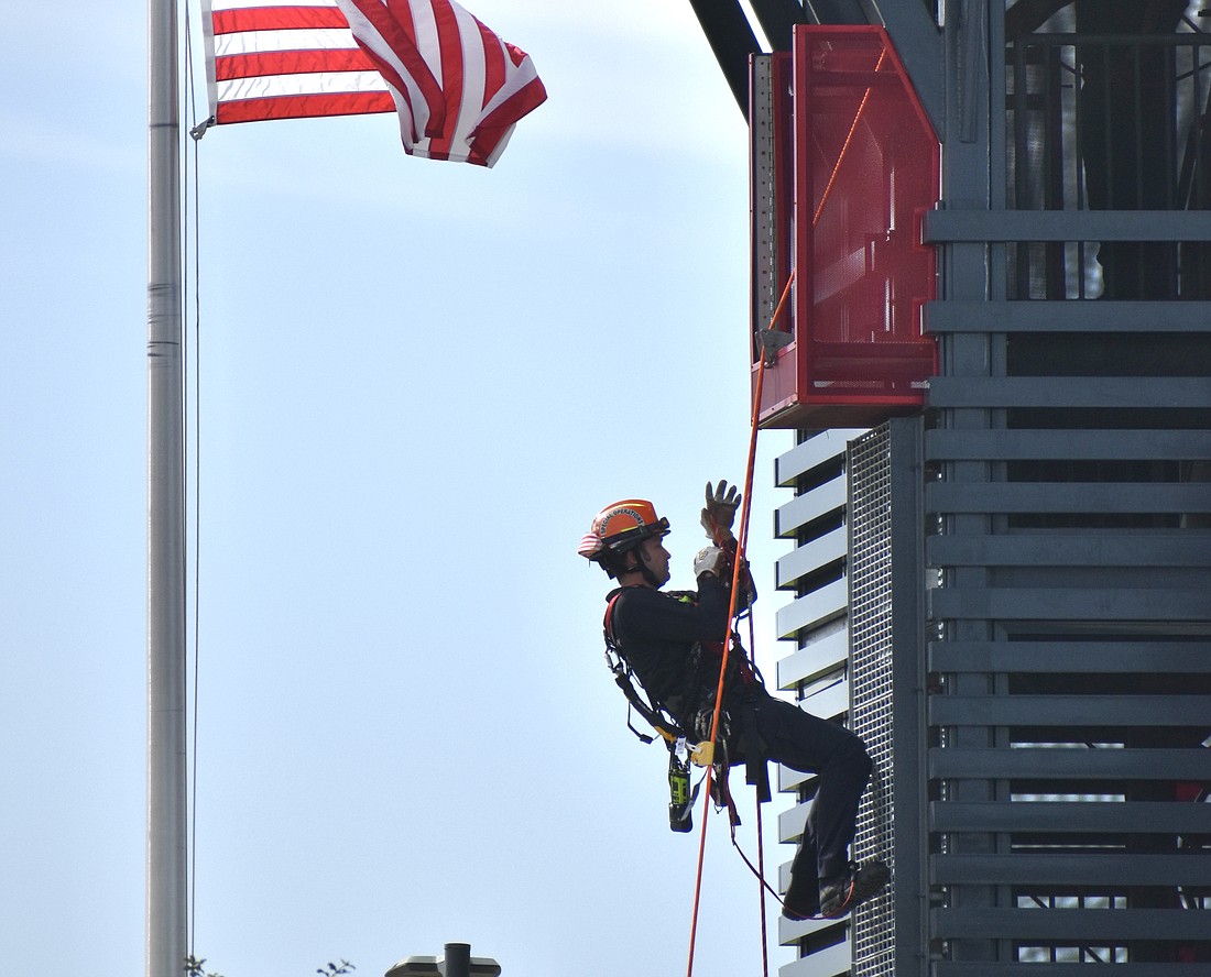 Firefighter/EMT Blaze Belligan climbs the tower.